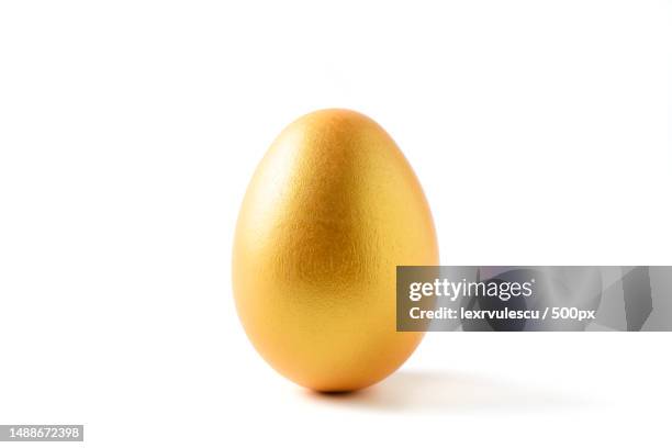 close-up of gold egg against white background,romania - gold ei stock-fotos und bilder