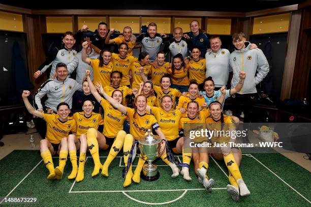 Wolverhampton Wanderers pose for a group photo in the changing room with the trophy following their victory during the Birmingham County Cup Women's...