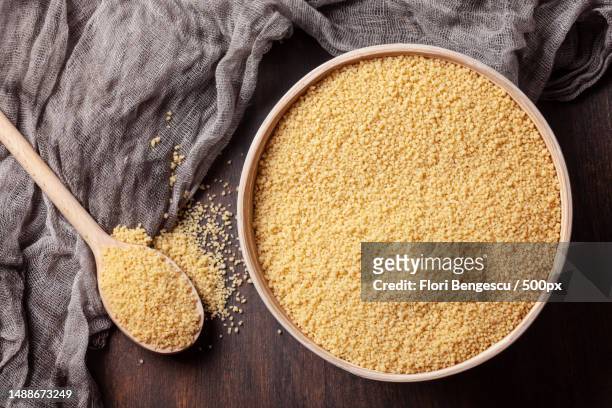 top view of raw couscous in bowl,romania - クスクス ストックフォトと画像