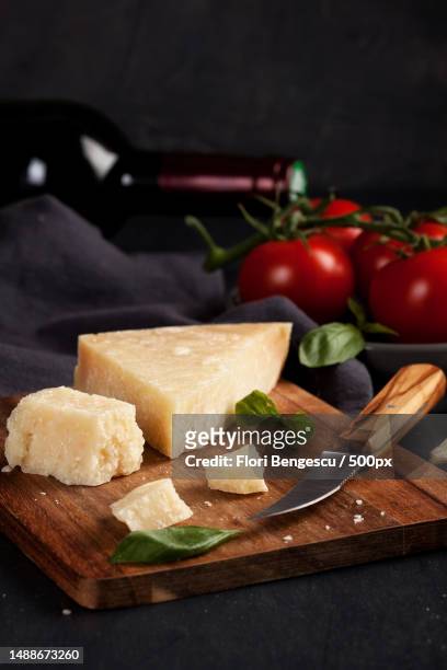 close-up of cheese with cheese and vegetables on cutting board,romania - hartkäse stock-fotos und bilder
