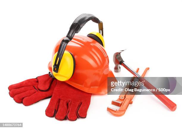 close-up of red gloves and hardhat against white background,moldova - casque audio stockfoto's en -beelden
