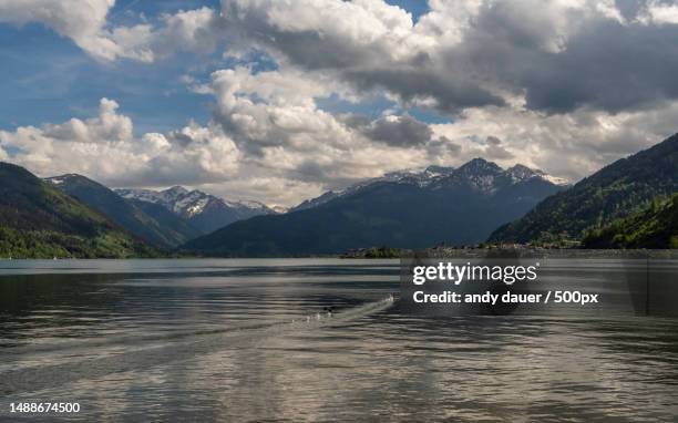 scenic view of lake by mountains against sky,zell am see,austria - andy dauer stockfoto's en -beelden
