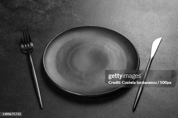 black cutlery on a concrete dark table dining table,romania - tisch besteck leer stock-fotos und bilder