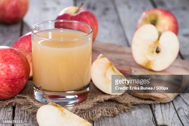 close-up of apples and juice on table,romania - apple juice stock pictures, royalty-free photos & images