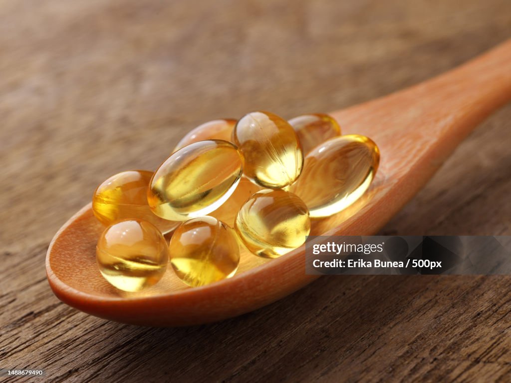 Fish oil capsules in a spoon,Romania