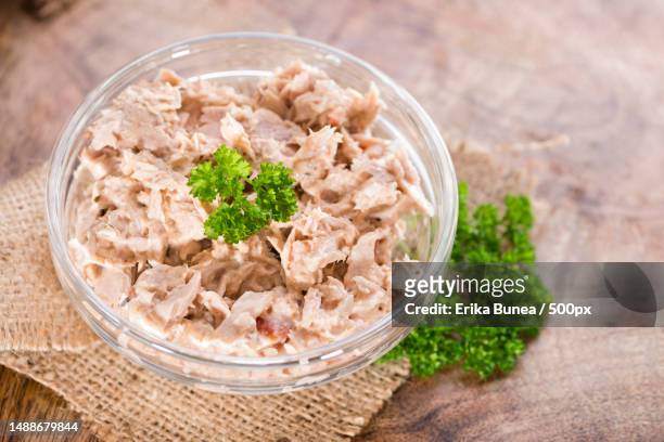 homemade tuna salad in a small bowl on wooden background,romania - tuna salad stock pictures, royalty-free photos & images