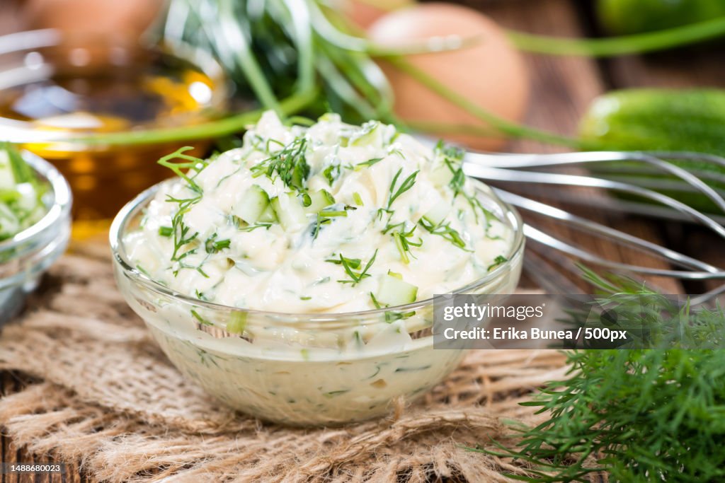 Sauce Remoulade homemade with fresh herbs on wooden background,Romania