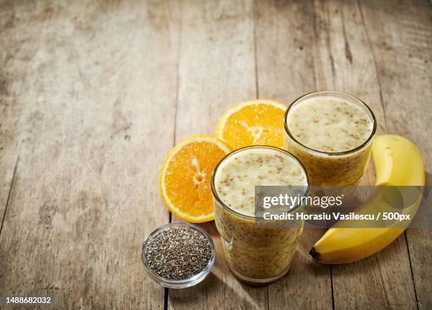 healthy banana and orange juice smoothie with chia seeds - banana smoothie stock pictures, royalty-free photos & images