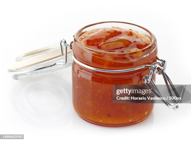 mango chutney in a jar on a white background - jam jar stock pictures, royalty-free photos & images