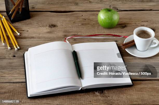 open diary with blank pages with a cup coffe and apple closeup on a wooden table copy space free space for text top view workplace - palm photos et images de collection