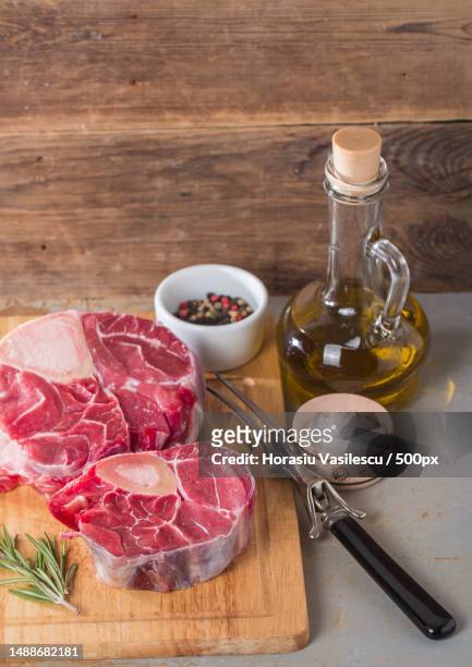 raw fresh cross cut veal shank and seasonings for making osso buco on wooden background - calf human leg stock pictures, royalty-free photos & images