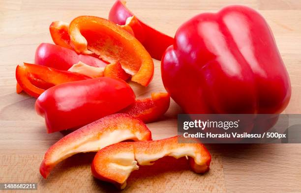 red pepper cut on a board - paprika stock pictures, royalty-free photos & images