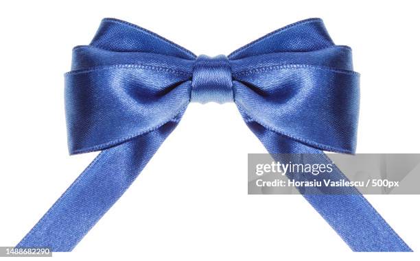 symmetric blue satin ribbon bow with horizontal cut ends isolated on white background,romania - boucle accessoire photos et images de collection