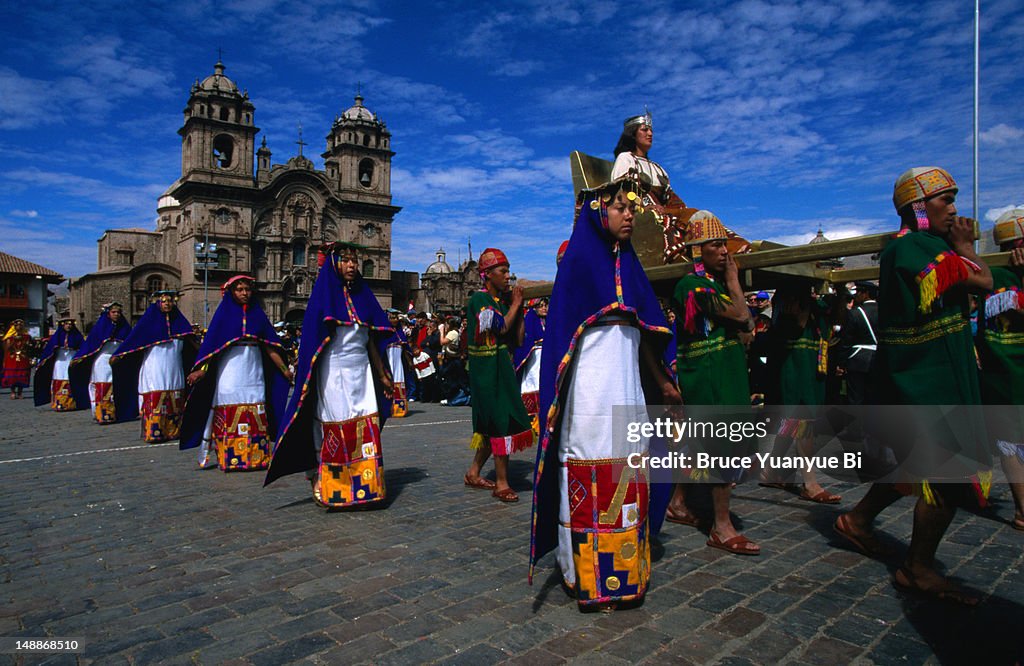 Inca warriors carry the Inca queen followed by the Virgins of the Sun on parade along the Plaza de Armas during the staged annual Inti Raymi festival.