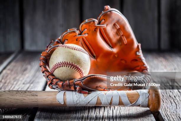 close-up of baseball glove on table - softball stockfoto's en -beelden