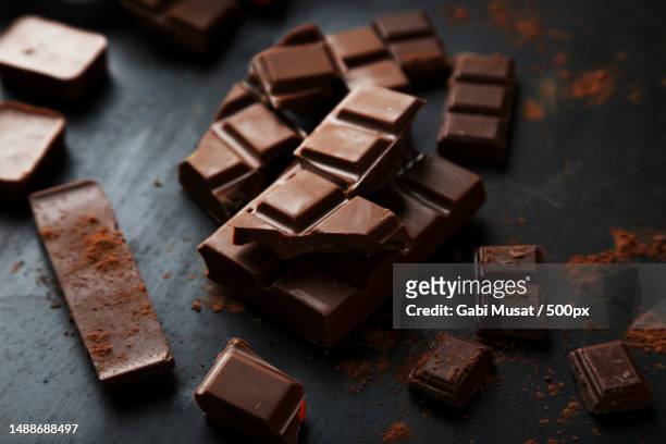 high angle view of chocolate bar on table - vollmilchschokolade stock-fotos und bilder
