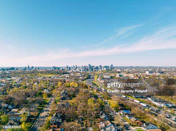 high angle view of busy traffic on interstate 65, weaving through a neighborhood south of downtown nashville, tennessee on a sunny afternoon in march - nashville stock pictures, royalty-free photos & images