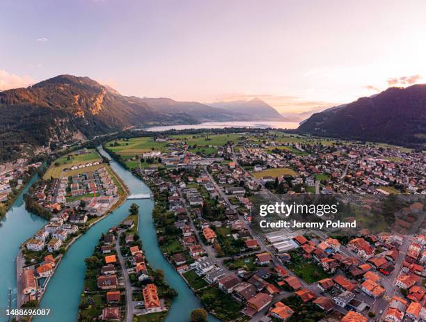 wide angle view, looking east, at brienzer rothorn over the aare river flowing through interlaken, switzerland - interlaken switzerland stock pictures, royalty-free photos & images