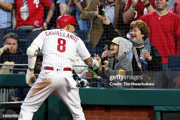 Nick Castellanos of the Philadelphia Phillies celebrates with his son after hitting a two run home run during the fourth inning against the Toronto...