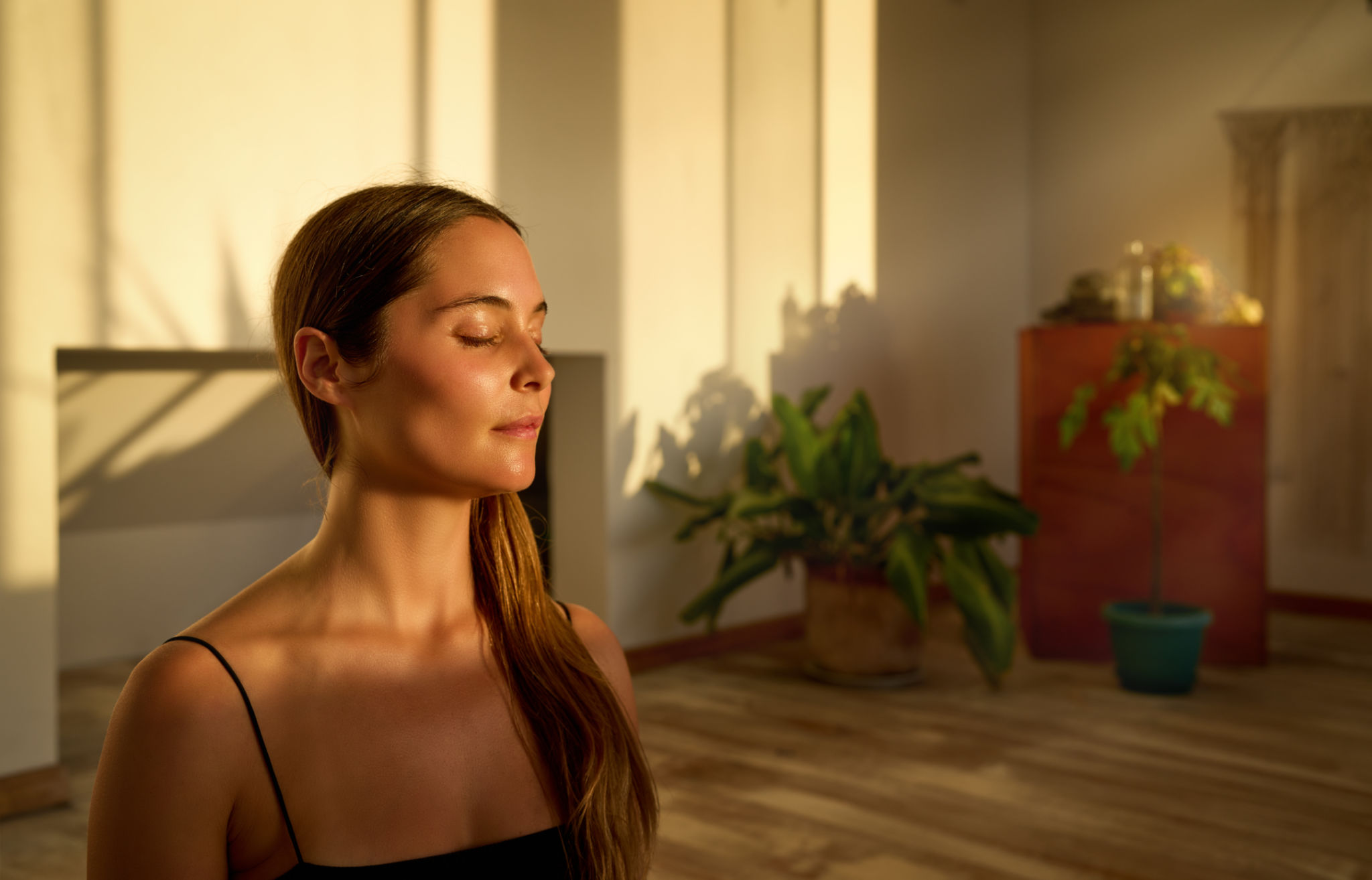 portrait young caucasian woman sitting with closed eyes meditating indoors portrait young caucasian woman sitting with closed eyes meditating indoors