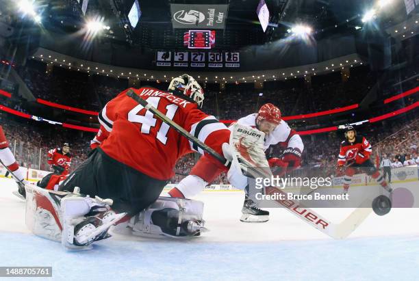 Jesper Fast of the Carolina Hurricanes scores a second period goal against Vitek Vanecek of the New Jersey Devils in Game Four of the Second Round of...