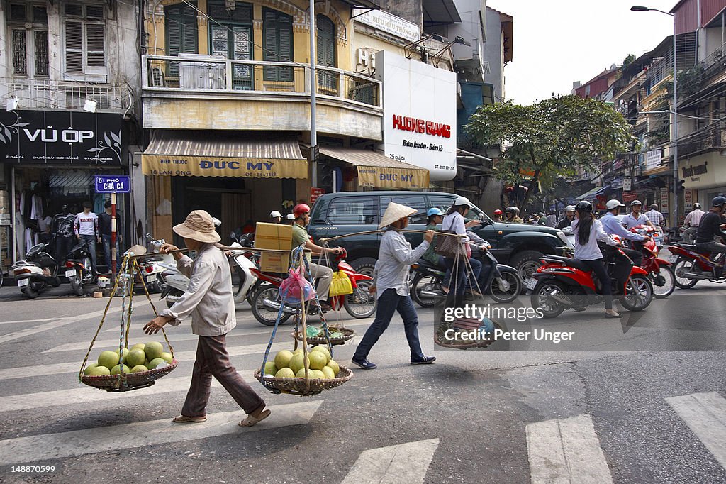 Food venders crossing street in old quarter.