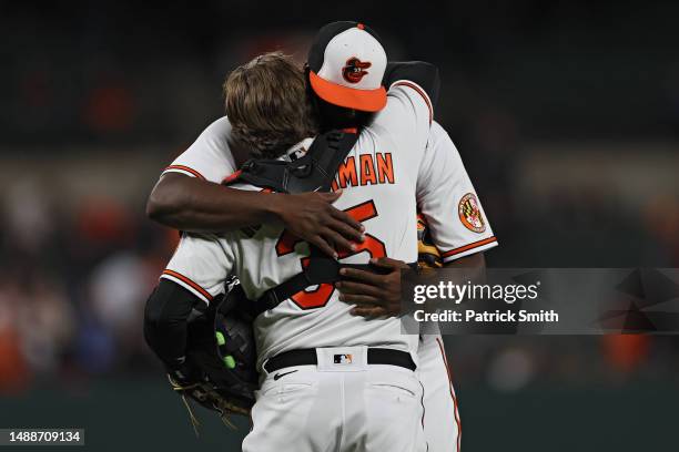 Pitcher Felix Bautista of the Baltimore Orioles celebrates after the final out of the game with catcher Adley Rutschman against the Tampa Bay Rays at...