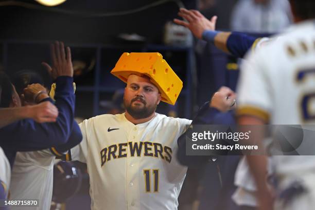 Rowdy Tellez of the Milwaukee Brewers is congratulated by teammates following a home run against the Los Angeles Dodgers during the seventh inning at...
