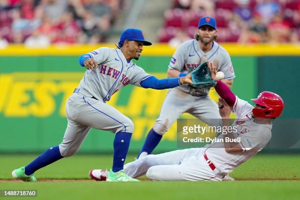 Wil Myers of the Cincinnati Reds slides into second base past Francisco Lindor of the New York Mets in the fifth inning at Great American Ball Park...