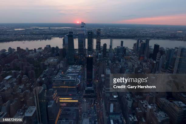 The sun is shrouded as it sets behind Hudson Yards as smoke from forest fires in Alberta, Canada drifts into the northeast of the U.S seen from the...