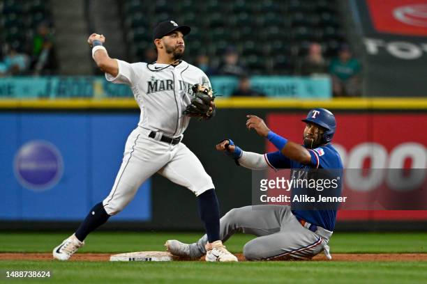 Ezequiel Duran of the Texas Rangers is tagged out at second base by Jose Caballero of the Seattle Mariners during the eighth inning at T-Mobile Park...