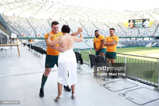 Angus Bell of the Wallabies dances with Argentinian tango dancers Karina and Fabian as Taniela Tupou and David Porecki of the Wallabies look on...