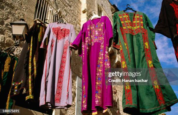 clothing hanging at the market. - middle east clothing stock pictures, royalty-free photos & images