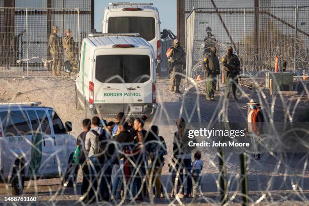 Border Patrol vehicles take away groups of vulnerable immigrants, including unaccompanied minors who had crossed over from Mexico on May 09, 2023 in...