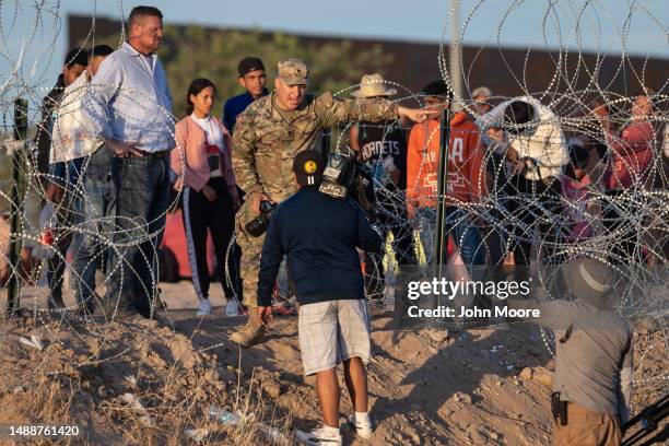 Texas National Guard soldier bars journalists from approaching migrants who had crossed over from Mexico on May 09, 2023 in El Paso, Texas. A surge...