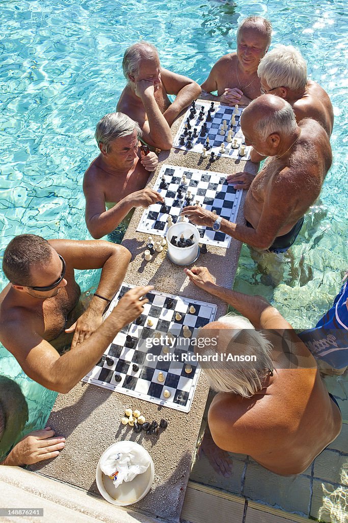 Men playing chess in pool at Szechenyi Baths.