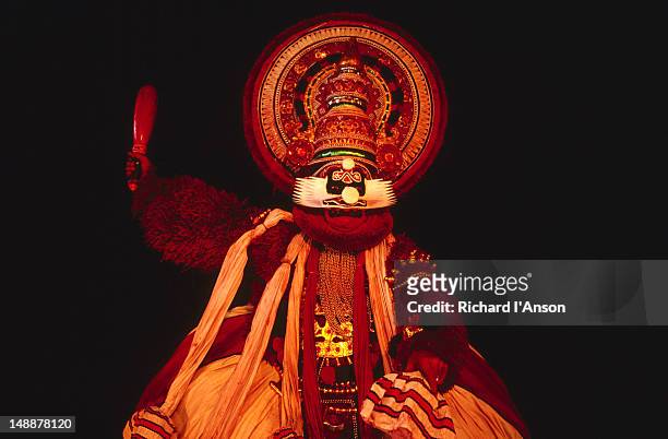 kathakali dancer in full make-up and costume on stage. - kathakali dancing stock pictures, royalty-free photos & images