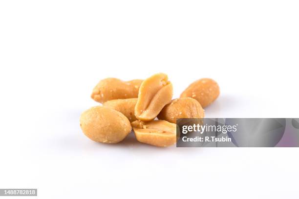 peanut nuts salt in heap isolated on white background - peanut stock pictures, royalty-free photos & images