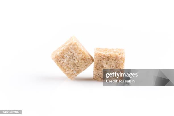 brown sugar cubes isolated on a white background - sugar stockfoto's en -beelden