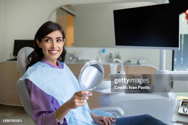 my teeth are now clean! - in dentist chair stock pictures, royalty-free photos & images