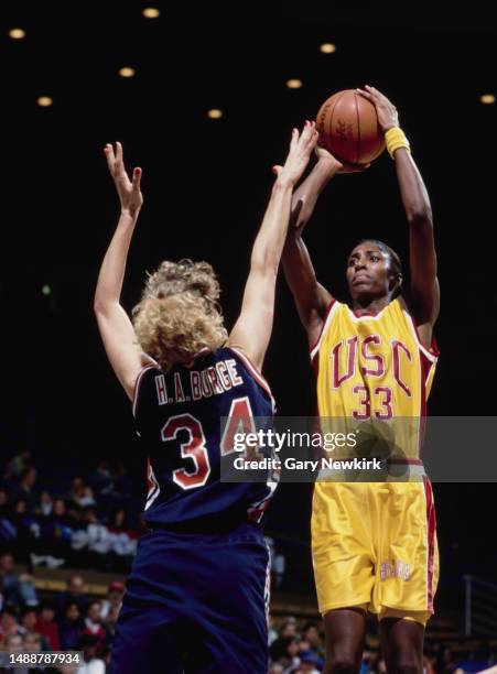 Lisa Leslie, Center for the University of Southern California Trojans women's basketball team prepares to shoot a jump shot over Heidi Burge, Forward...