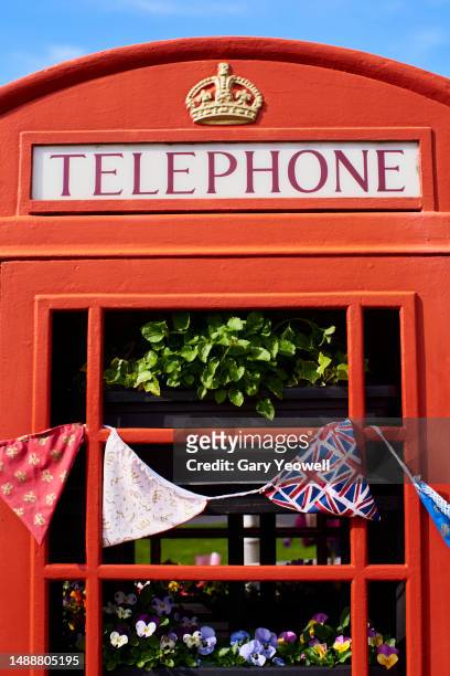 coronation celebration, close-up of union jack bunting on a telephone box - vertical banner stock pictures, royalty-free photos & images