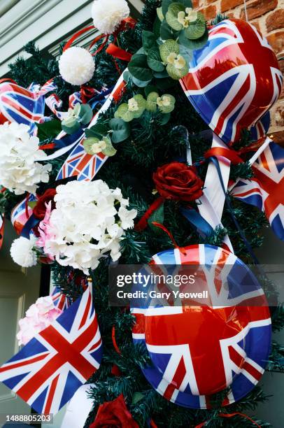 coronation celebration, close-up decoration of union jack bunting and hats - vertical banner stock pictures, royalty-free photos & images