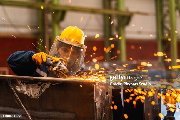 metal worker using a grinder - slijptol stockfoto's en -beelden