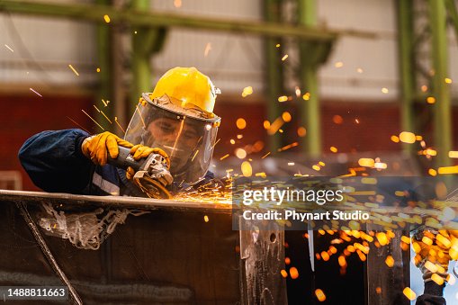 Metal worker using a grinder Metal worker using a grinder