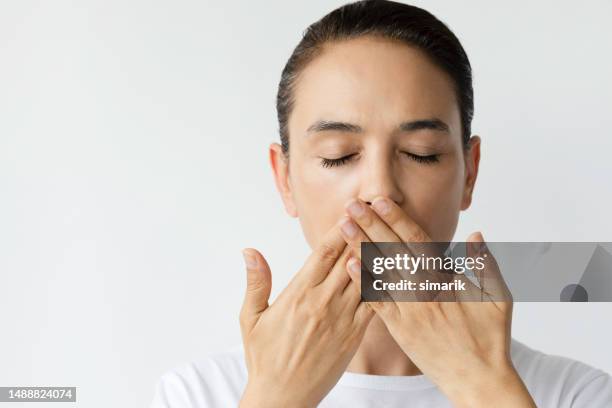 bad breath - hand cover mouth stock pictures, royalty-free photos & images