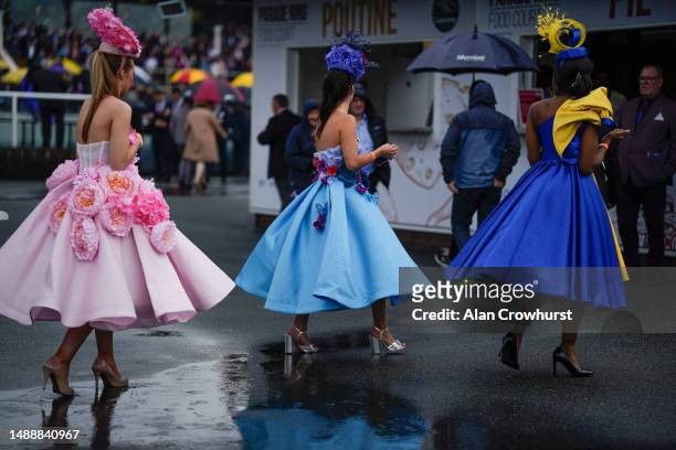 Fashion in the rain at Chester Racecourse on May 10, 2023 in Chester, England.