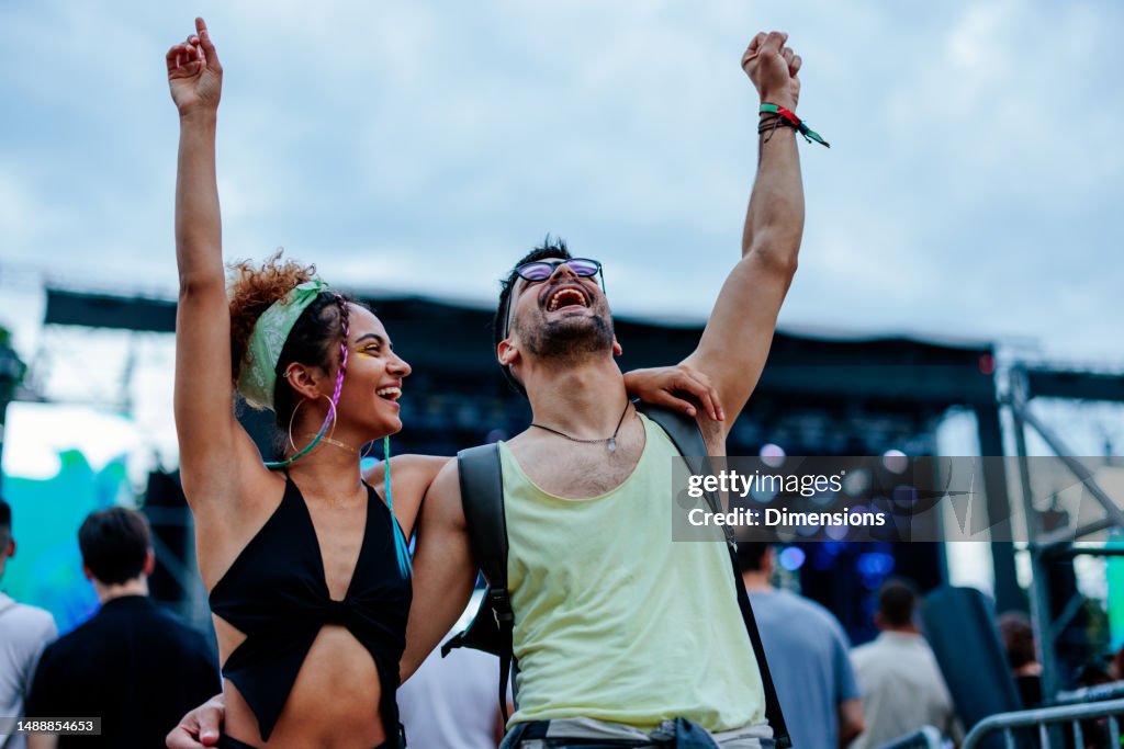 Stylish couple enjoying music at concert