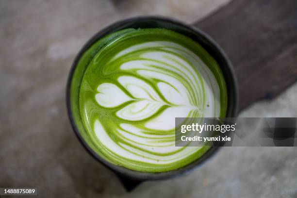 closeup of a matcha latte with a beautiful pattern. - matcha tea stock pictures, royalty-free photos & images