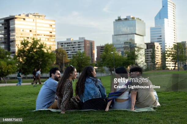 a group of five friends prepare to watch the sunset over the city - santiago chile sunset stock pictures, royalty-free photos & images